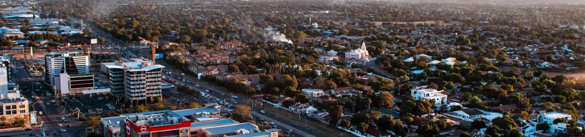 A top view of mountains , trees and buildings